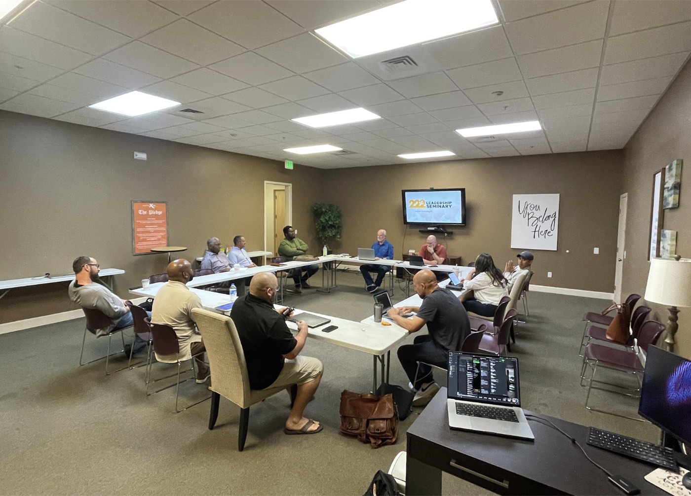 A cohort of ministry leaders studying together around tables.