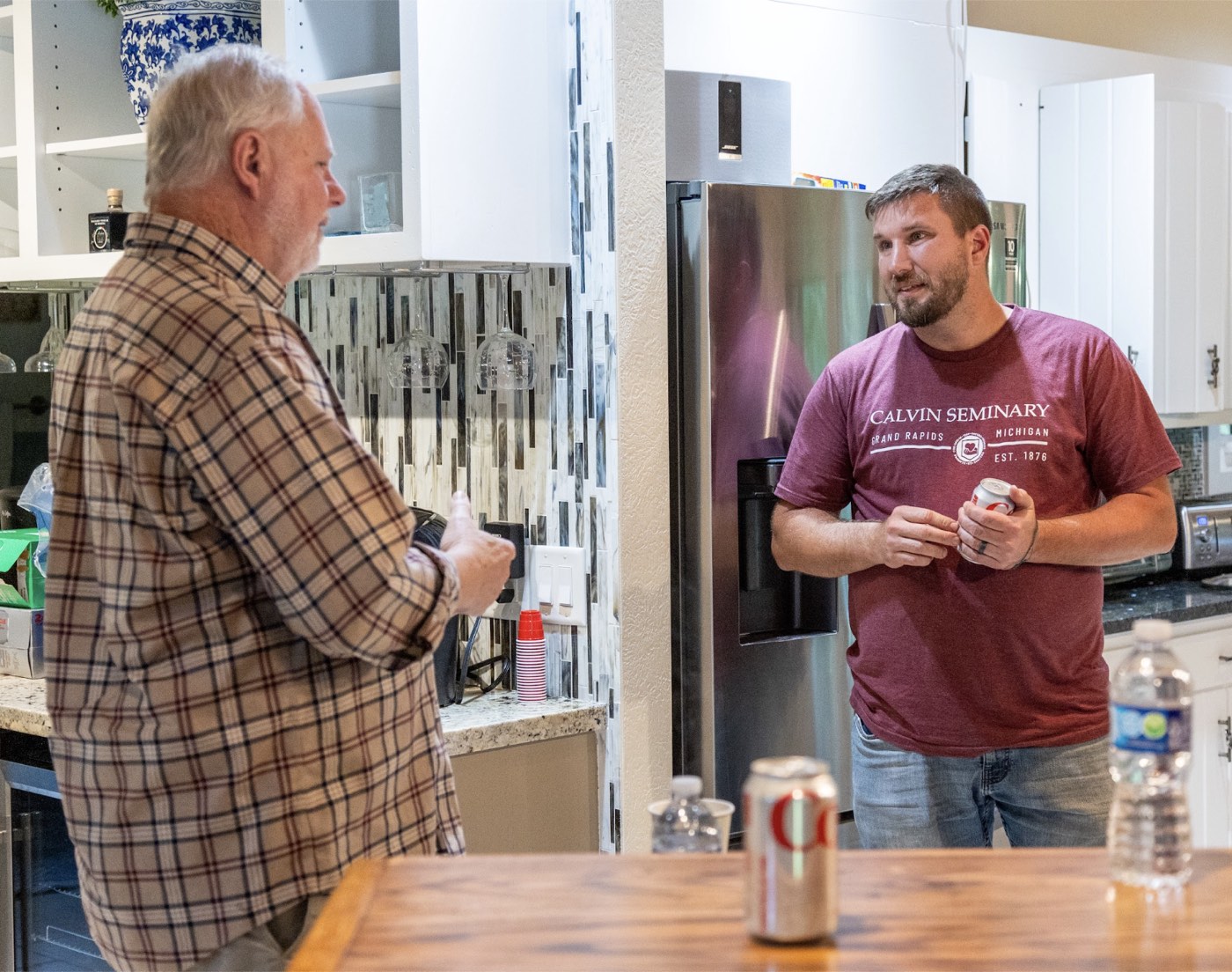 Two men in conversation during a seminary community gathering.