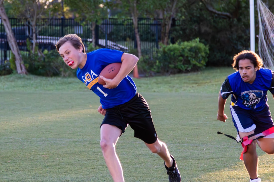 A Sunlight student carrying the football during a flag-football game.